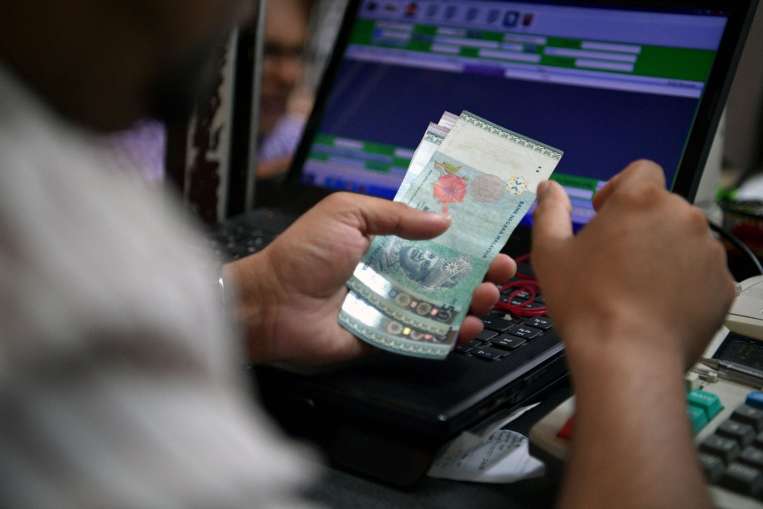 Malaysia takes action as ringgit plunges, Business News & Top Stories