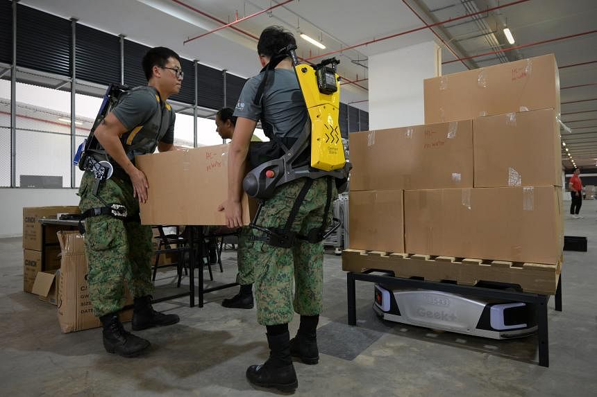 Soldiers don exoskeleton suits, operate automated packing line to ...